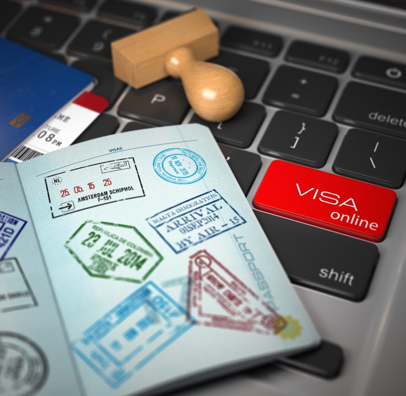 Visa online application concept. Open passport with visa stamps